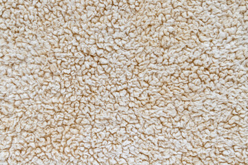 Beige soft background of plush fabric.