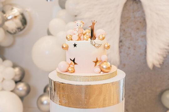 Festive luxury cake for a one-year-old child's birthday. Gold balls and na tural ingredients