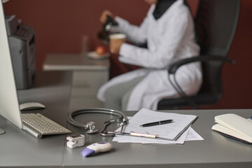 Selective focus of medical equipment placed on office table, doctor having lunch break on background