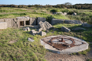 Old artillery battery position with german bunkers and concrete trench at Pointe du Hoc,...