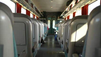 Obraz premium Passenger perspective walking through train corridor in movement, POV of person inside high-speed transportation traveling
