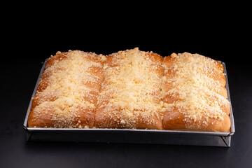 German schneke bread with sweet crumbs in a metal pan
