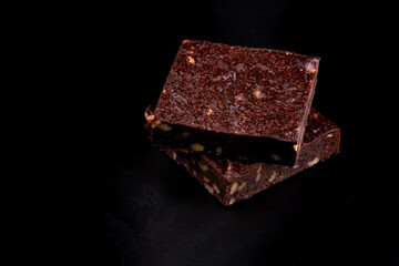 two chestnut brownies isolated on black background from above