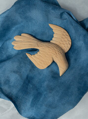 Descending dove with imaginary blue sky is surrounded or edged with white fluffy fabric...