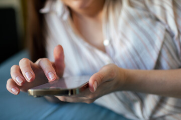 Young woman using a smartphone in bed