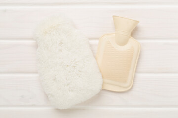 Fluffy water warmer bag on wooden background