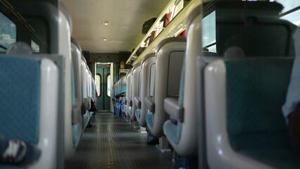Train corridor in motion, high-speed transportation in Europe view seats durign day trip, traveling concept