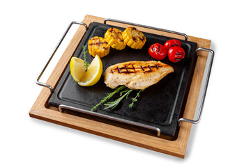 Grilled chicken breast with tomatoes, corn and lemon. Lunch. Isolated.