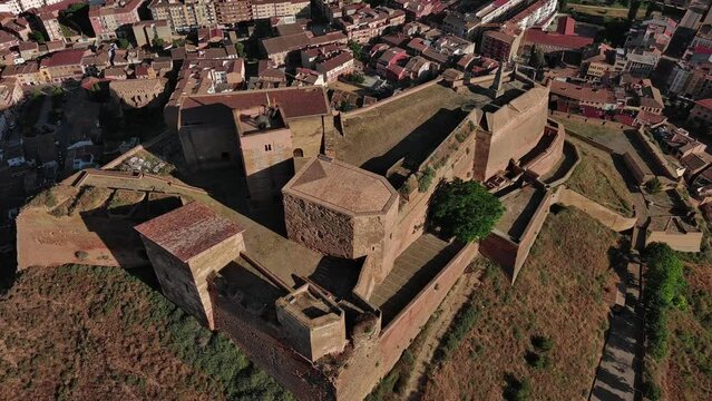 Historic Templar Castle in Monzon, Huesca, with surrounding town landscape, sunny day