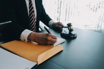 Judge gavel with Justice lawyers having team meeting at law firm background. Concepts of Law and...