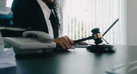 Judge gavel with Justice lawyers having team meeting at law firm background. Concepts of Law and Legal services.