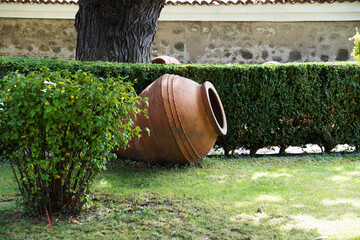 fallen clay jug as an element of landscape design in the garden