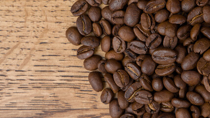 Coffee beans on wooden background. Top view with copy space