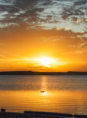 Golden hour on lake with beautiful cloud silhouettes