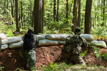 two elite soldiers stand guard, resolute and vigilant, defending the area against attacking enemies...