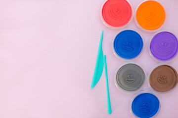 View from above colorful air dry clay on pink background with copy space