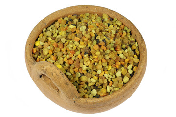 organic bee pollen in a handmade earthenware dish isolated on white background
