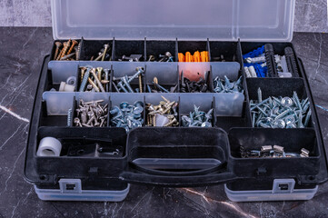Screws and other fasteners in a plastic tool box.