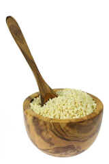 chopped almonds in an olive wood bowl with spoon isolated on white background