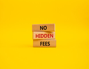 No hidden fees symbol. Concept word No hidden fees on wooden blocks. Beautiful yellow background. Business and No hidden fees concept. Copy space