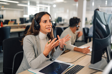 Call center female agent answering incoming calls with a headset - obrazy, fototapety, plakaty