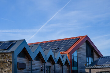 Energy and power, solar panels, roof mounted on a sunny day. Renewable energy saving, harnessing concept.