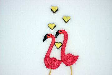 Two flamingo-shaped lollipop candies