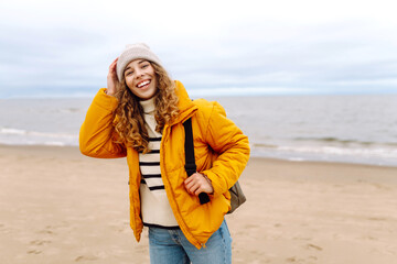 Happy tourist walking by the sea. Lifestyle, travel, tourism, nature, active life.