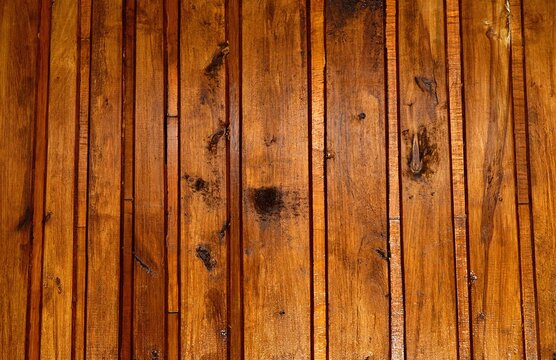 Old birch paneling painted with a brown varnish