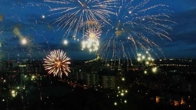 Fireworks in cloudy sky above night cityscape. Aerial view