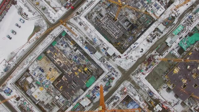 Large construction site with many cranes at winter day. Aerial view
