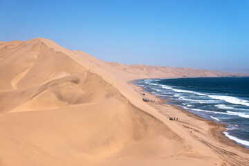 Fototapeta na wymiar Sand dunes of the Namib Desert and the Atlantic Ocean, Sandwich Harbor, Namib Naukluft Park, Namibia, Africa