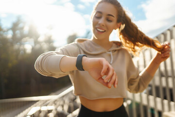 Young woman with smart watch goes in for sports, performs sport exercises. Sport, Active life,...
