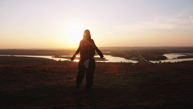 A girl dancing on the background of a bridge