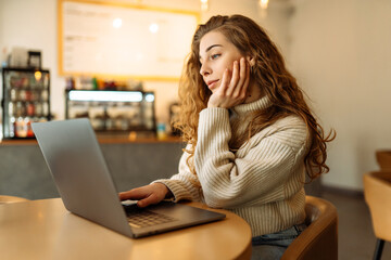 Happy woman sitting on cafe with laptop. Concept for education, business, shopping, blog or...