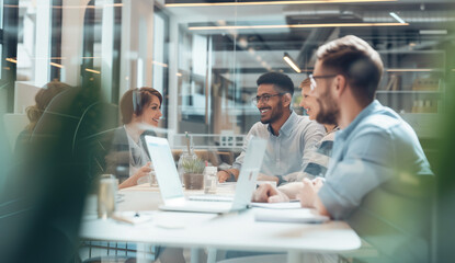 people sitting at the table in front of the computer