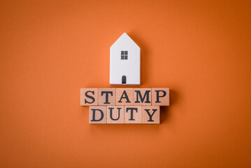 The inscription Stamp Duty made of wooden cubes on a plain background