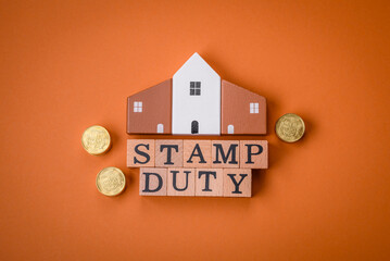 The inscription Stamp Duty made of wooden cubes on a plain background