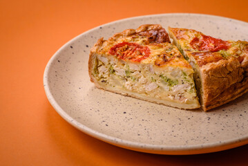 Delicious quiche with tomato, cheese, chicken, spices and herbs