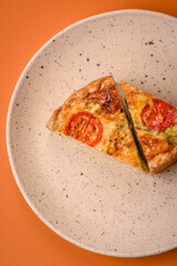 Delicious quiche with tomato, cheese, chicken, spices and herbs