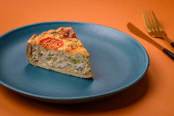 Delicious quiche with tomato, cheese, chicken, spices and herbs