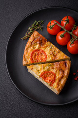 Delicious quiche with tomato, cheese, chicken, spices and herbs