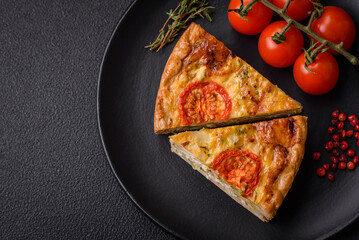 Delicious quiche with tomato, cheese, chicken, spices and herbs