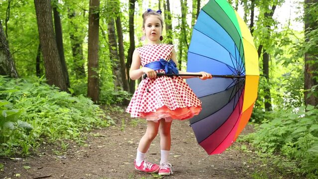 Girl standing and doing step forward and backward in forest.