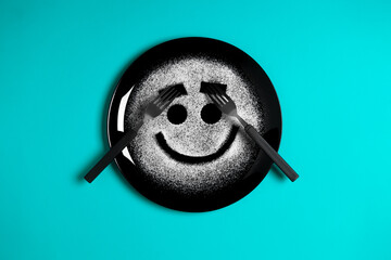 Smiling face, concept made with plate and flour, cyan background, star shaped eyes, black plate, happy mood, facial expressions, forks in the shape of arms with different positions