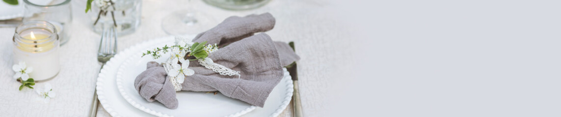 Romantic elegant luxury wedding table decor with white fresh spring blooming cherry apple tree flowers. Glass, candles, floral decoration for special marriage holiday event. Zero waste, banner