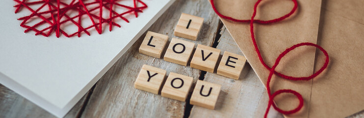 Beautiful wooden letterI love you on wooden background. Lovely cute handmade greeting card with red...