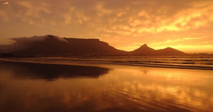 Table Mountain and Lion's head view from sunset beach Blouberg during a colourful sunset, Cape Town, South Africa