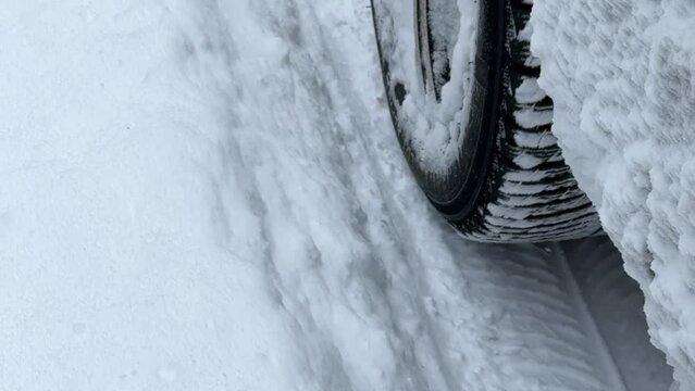 Powerful SUV vehicle struggling to maintain traction and control on the winter country road with fresh snow