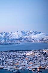 Fjellheisen viewpoint over tromso city in north of norway in winter time with the sunset over the fjords